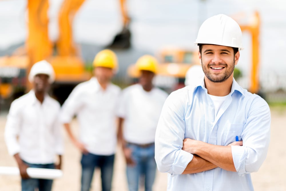 Male architect at a construction site looking happy-1