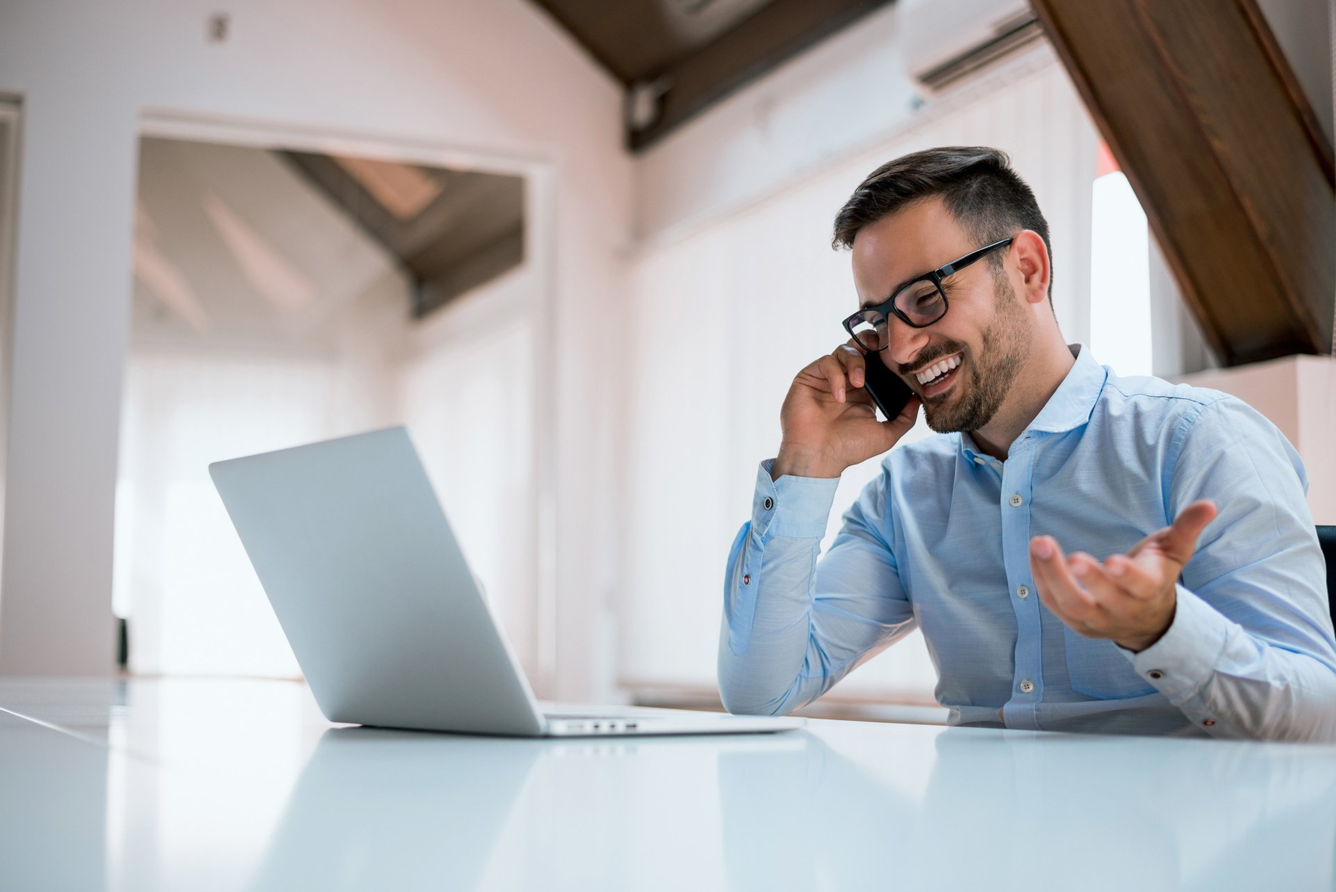 businessman-using-a-computer-talking-on-the-mobile-phone